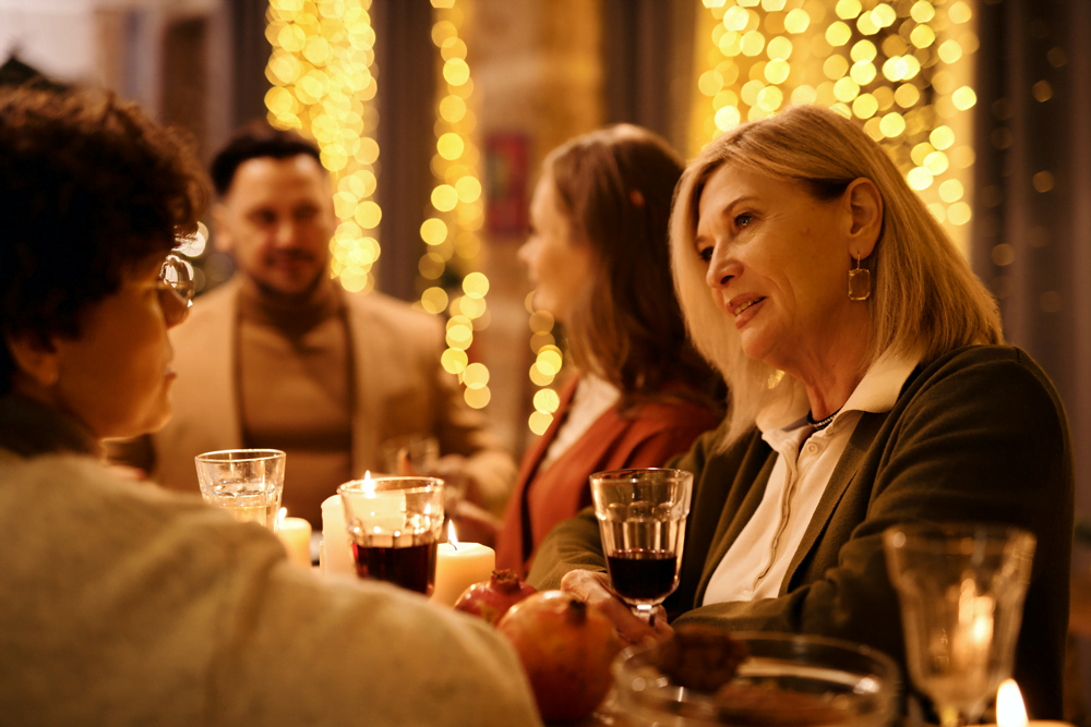 A senior woman participating in conversation during family dinner